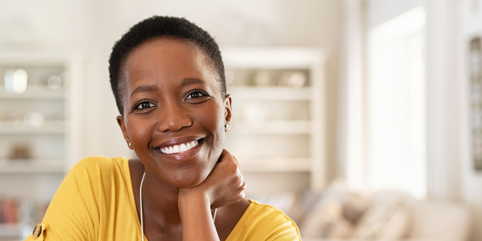 woman comfortable at home smiles at the camera